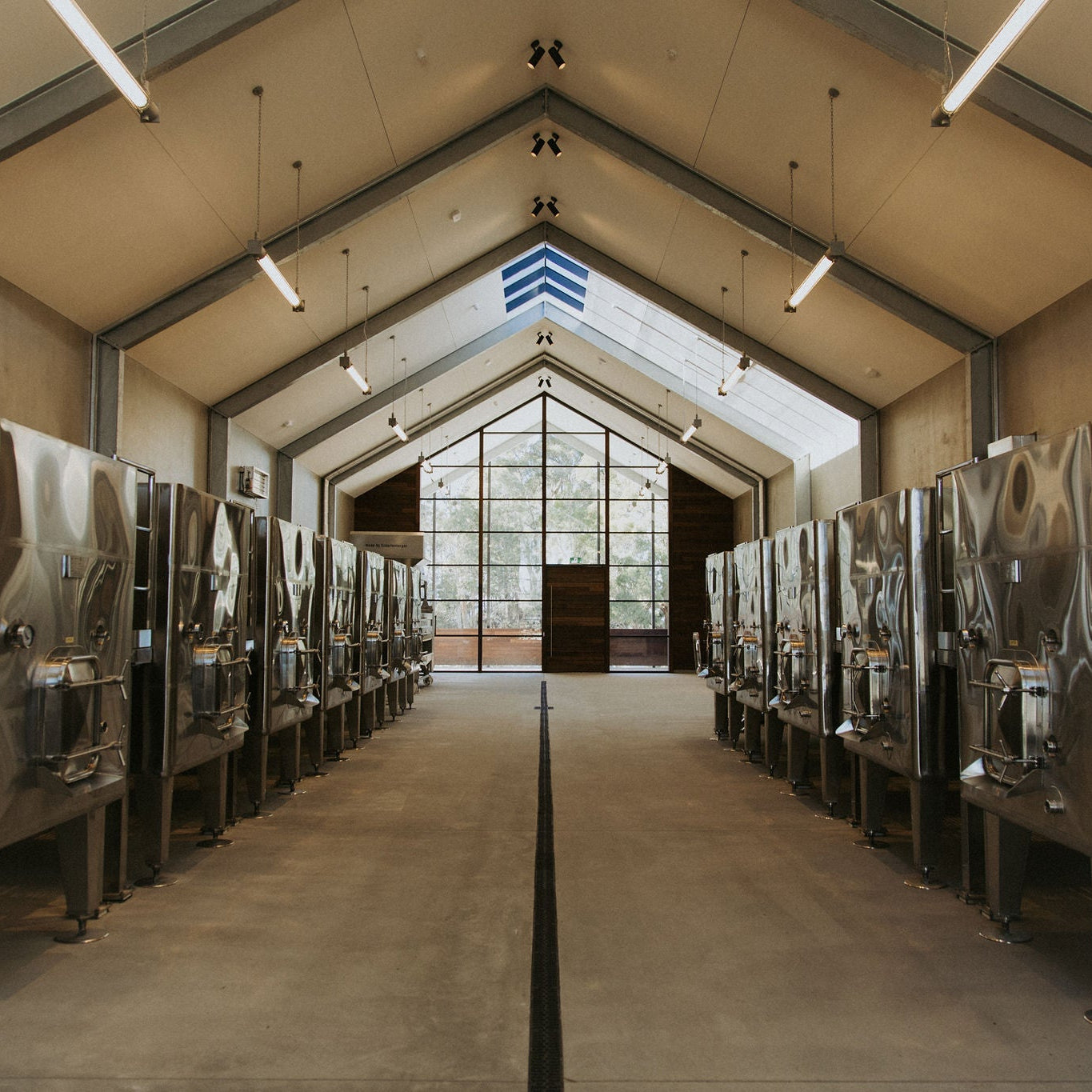 Inside the red fermentation hall of our Tamar Valley winery in Northern Tasmania, with rows of our open top fermenters.